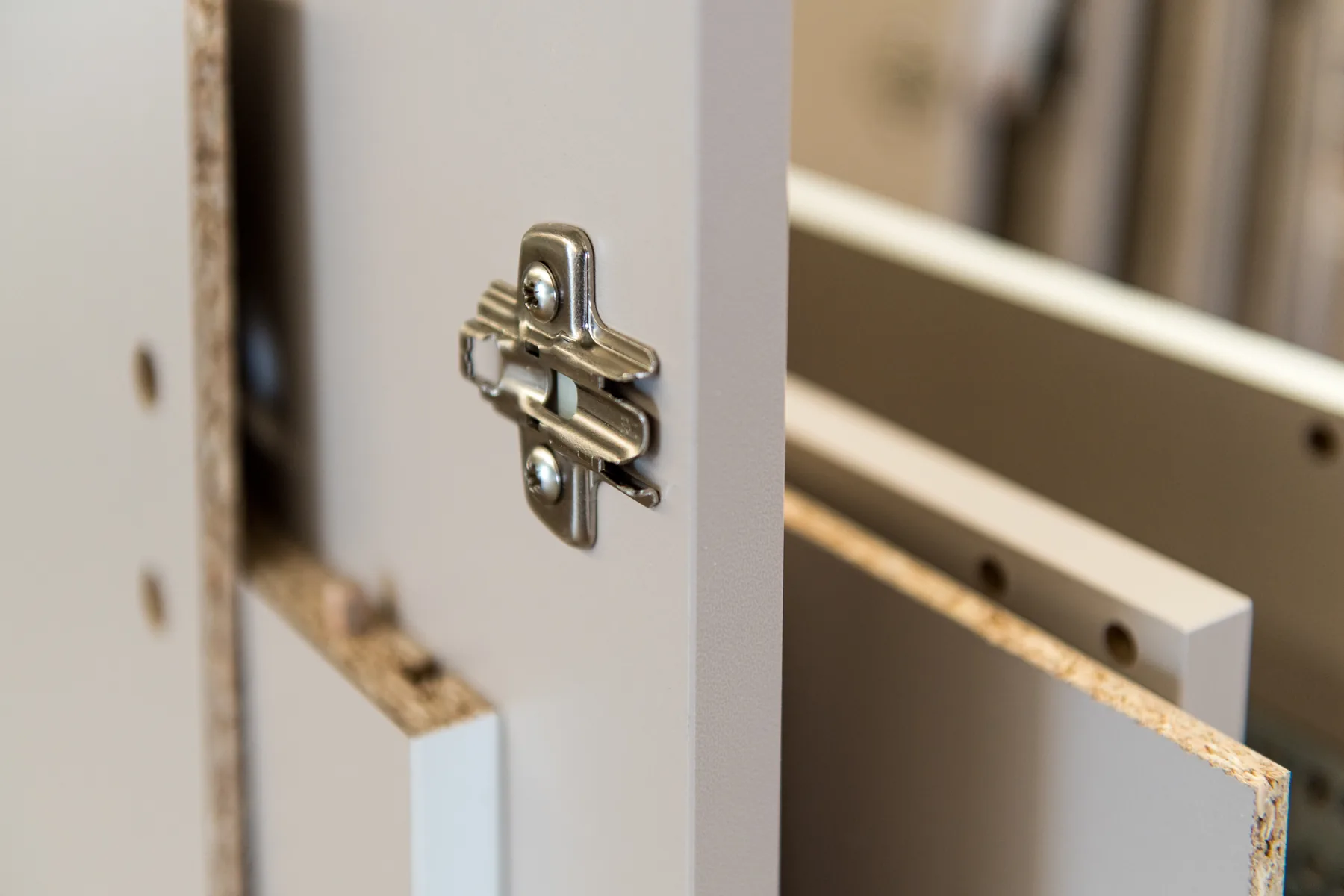 Close-up of cabinet hardware and pre-drilled panels