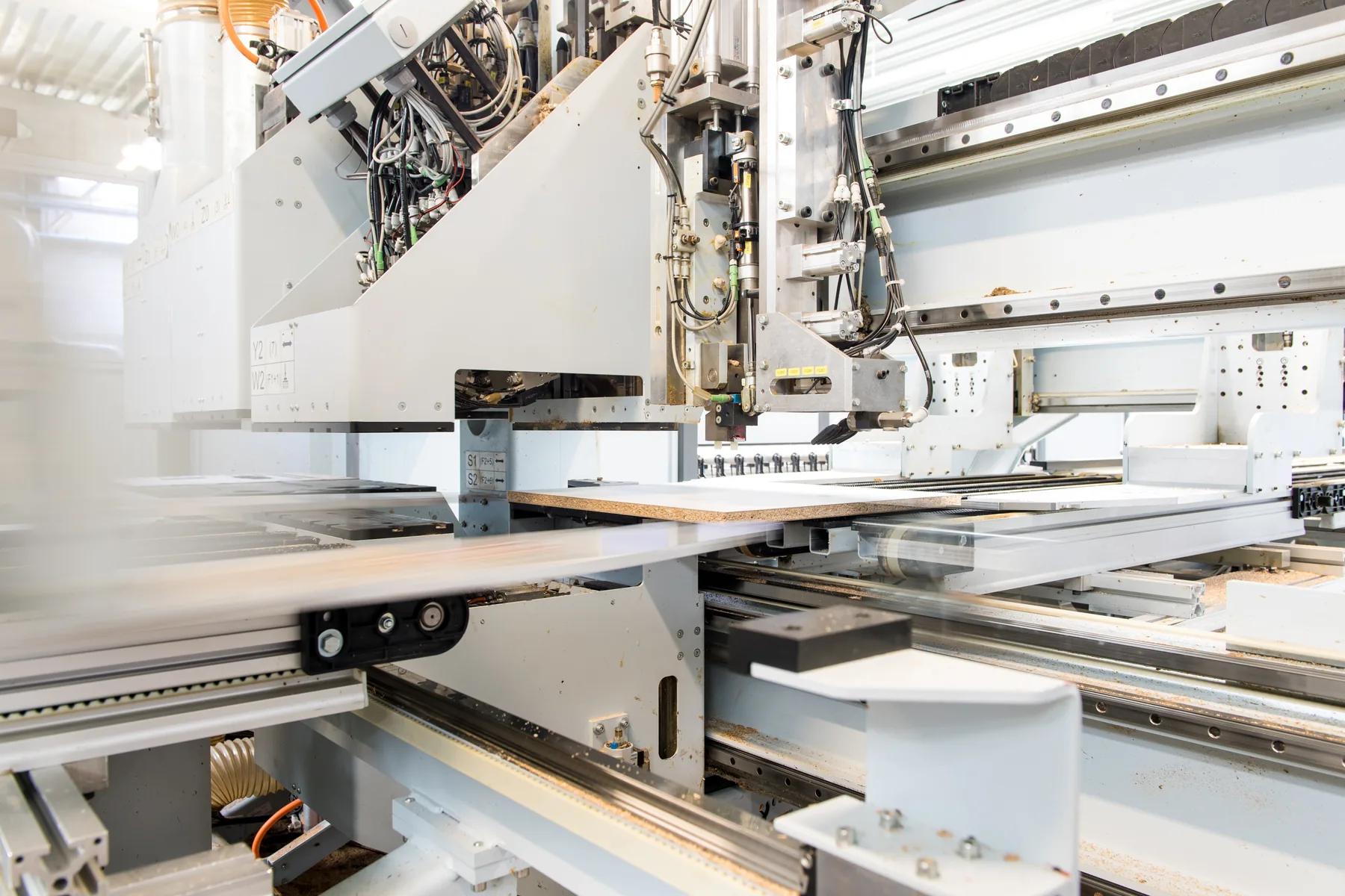 CNC tooling head above a panel part