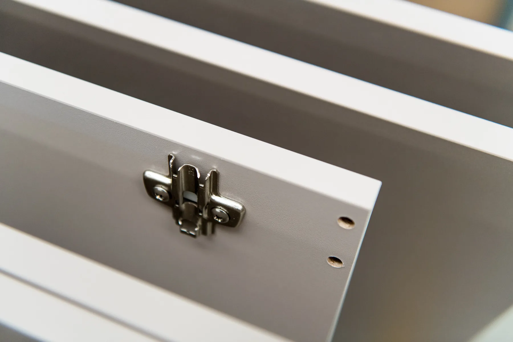 Hinge plate and pre-drilled holes on a finished panel